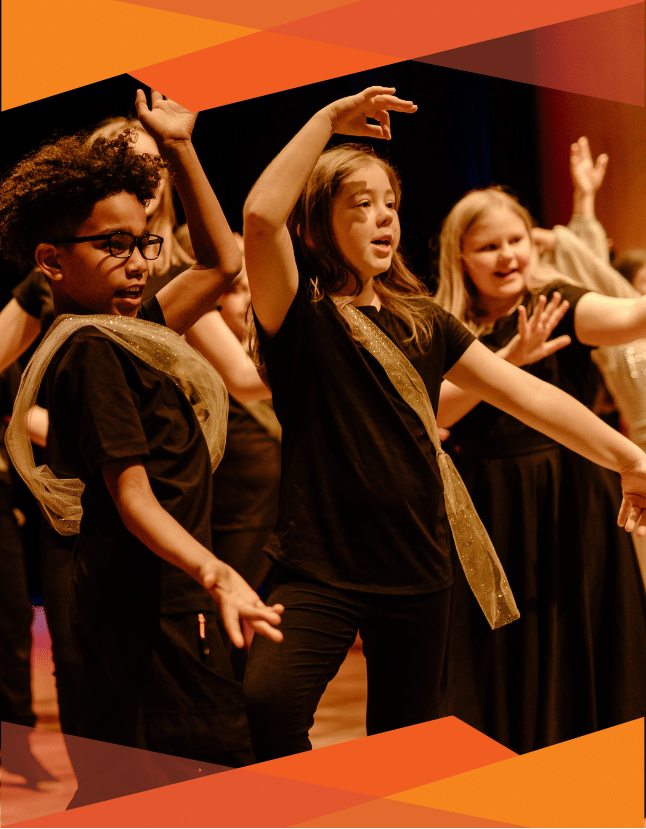 Dancers in black and gold costumes dance in GFAA's production of Aladdin Kids.